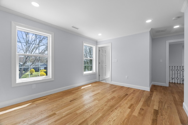 unfurnished room featuring light wood-type flooring, ornamental molding, visible vents, recessed lighting, and baseboards
