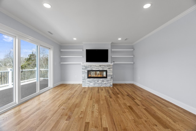 unfurnished living room with visible vents, a stone fireplace, light wood finished floors, and baseboards