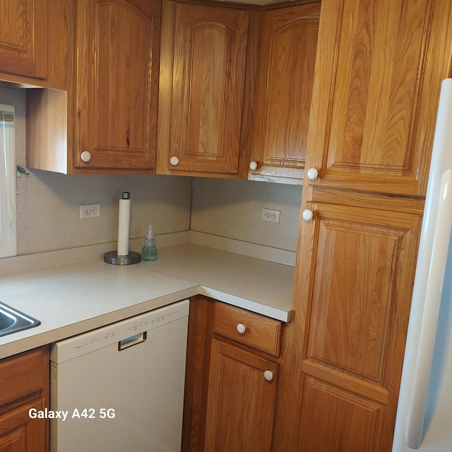39 Old Wood Rd, Mansfield, CT 06268 - kitchen with white appliances, light countertops, and brown cabinetry