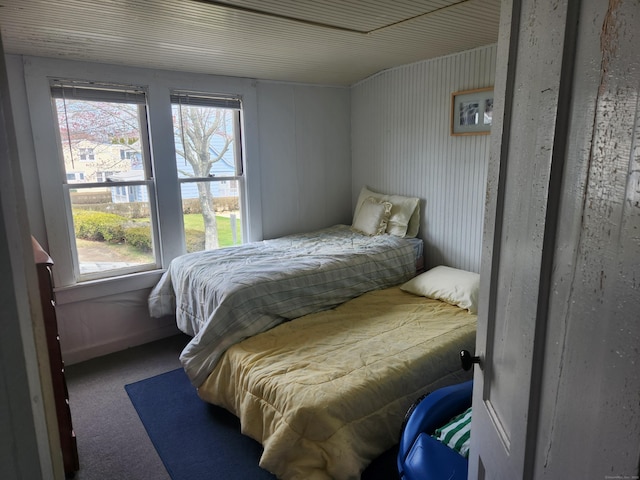 bedroom with multiple windows and carpet flooring