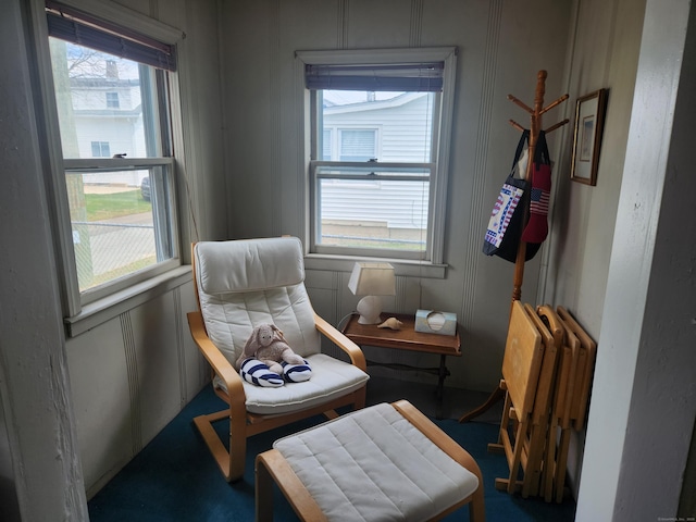 sitting room featuring a decorative wall