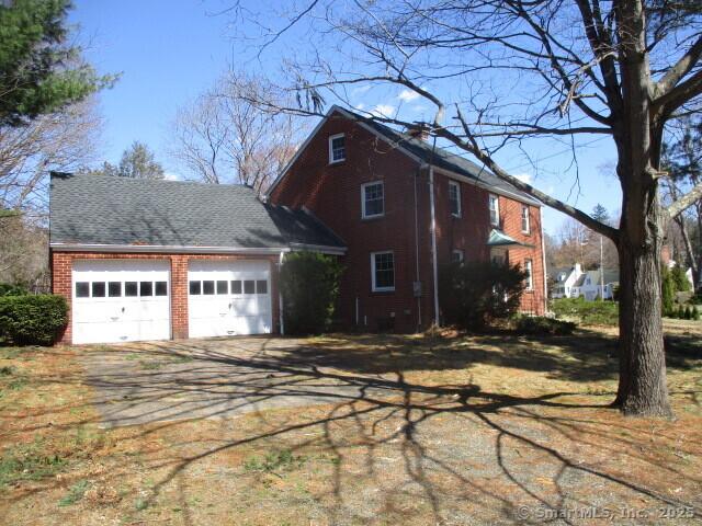 view of home's exterior featuring driveway and an attached garage