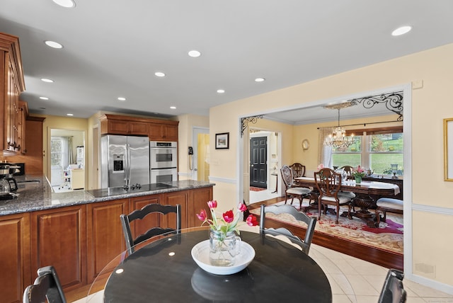 dining room with recessed lighting, a notable chandelier, and light tile patterned flooring