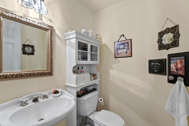 bathroom featuring toilet and a sink