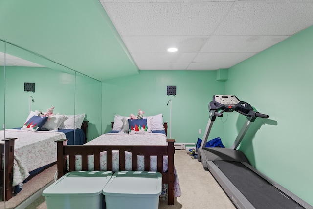 carpeted bedroom featuring recessed lighting and a paneled ceiling