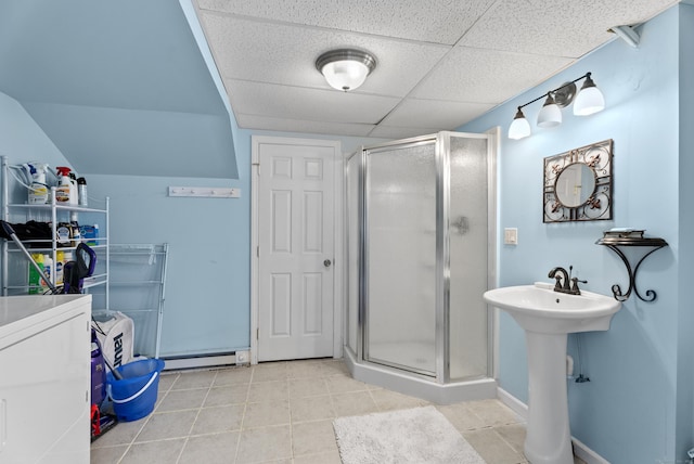 full bath with tile patterned floors, a shower stall, and a sink