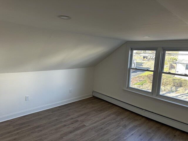 384 Sylvan Ave, Waterbury, CT 06706 - additional living space featuring a baseboard heating unit, lofted ceiling, dark wood-type flooring, and baseboards