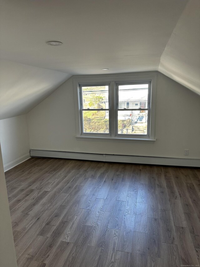 384 Sylvan Ave, Waterbury, CT 06706 - bonus room with a baseboard heating unit, lofted ceiling, healthy amount of natural light, dark wood finished floors, and baseboards