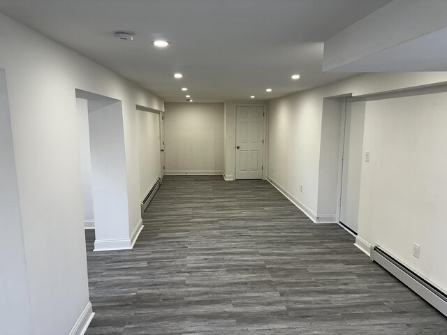 384 Sylvan Ave, Waterbury, CT 06706 - finished basement featuring a baseboard heating unit, recessed lighting, baseboards, and dark wood-style floors