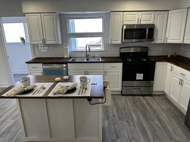 384 Sylvan Ave, Waterbury, CT 06706 - kitchen with stainless steel appliances, wooden counters, a sink, and plenty of natural light