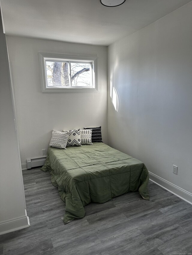 384 Sylvan Ave, Waterbury, CT 06706 - bedroom featuring a baseboard heating unit, wood finished floors, and baseboards