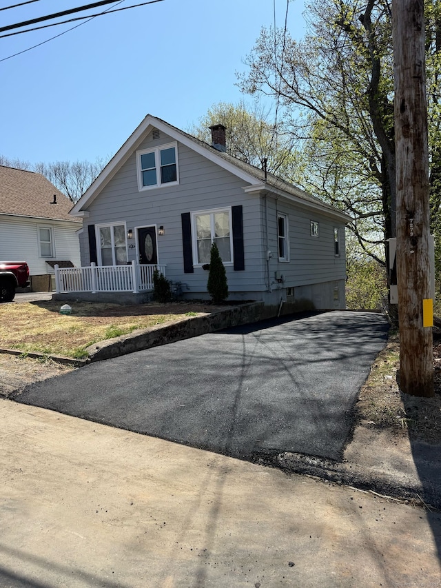 384 Sylvan Ave, Waterbury, CT 06706 - view of front of home featuring a chimney, driveway, and a porch