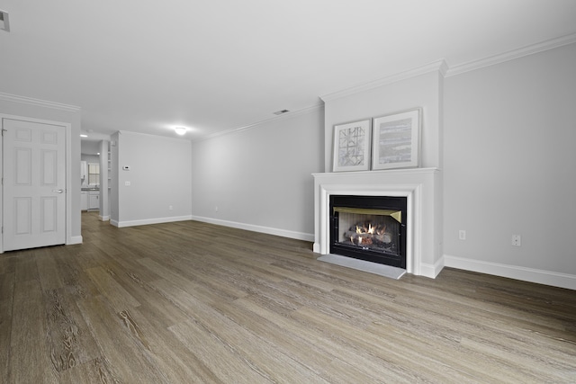 49 Glenbrook Rd Apt 209, Stamford, CT 06902 - unfurnished living room featuring crown molding, baseboards, wood finished floors, and a fireplace with flush hearth