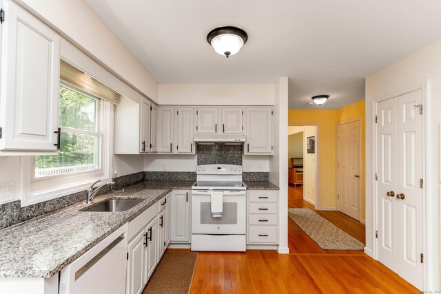 2 Cassella Dr, Wallingford, CT 06492 - kitchen with white electric range oven, a sink, dishwasher, light wood-style floors, and under cabinet range hood