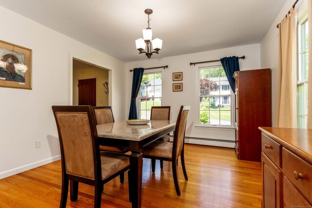 2 Cassella Dr, Wallingford, CT 06492 - dining room with a baseboard heating unit, light wood-style floors, a chandelier, and baseboards