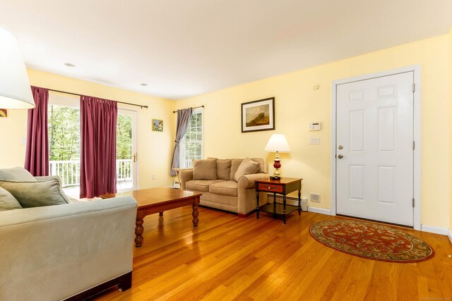 2 Cassella Dr, Wallingford, CT 06492 - living area featuring light wood-style floors, baseboards, baseboard heating, and a baseboard heating unit