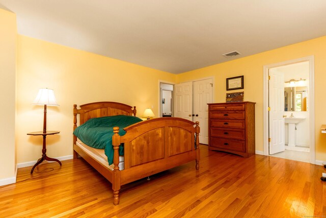 2 Cassella Dr, Wallingford, CT 06492 - bedroom featuring light wood finished floors, baseboards, and ensuite bath