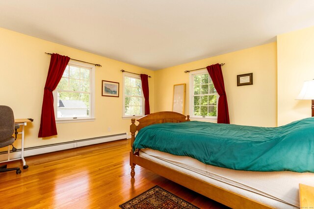 2 Cassella Dr, Wallingford, CT 06492 - bedroom featuring wood finished floors and a baseboard radiator