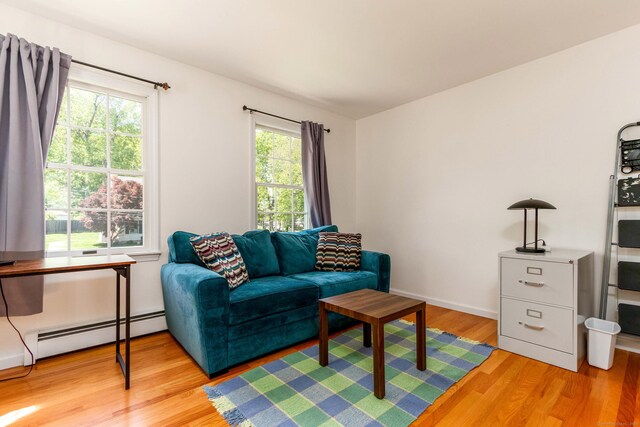 2 Cassella Dr, Wallingford, CT 06492 - living area with a baseboard heating unit and light wood-type flooring
