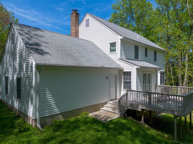 2 Cassella Dr, Wallingford, CT 06492 - rear view of property featuring a wooden deck, a lawn, a chimney, and a shingled roof