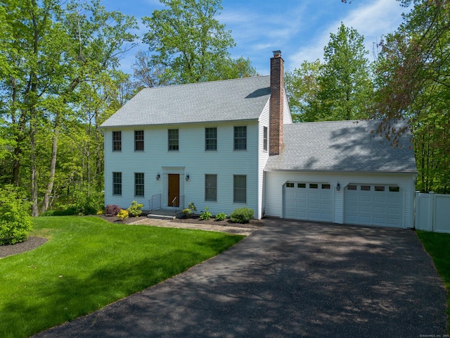 2 Cassella Dr, Wallingford, CT 06492 - colonial-style house with a garage, asphalt driveway, a chimney, and roof with shingles