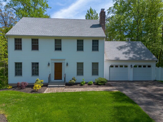 2 Cassella Dr, Wallingford, CT 06492 - colonial-style house featuring a chimney, a shingled roof, a garage, a front lawn, and driveway