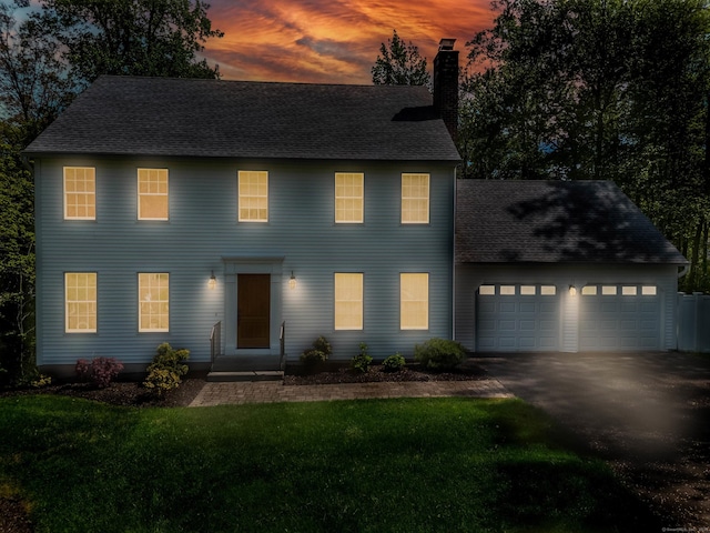 2 Cassella Dr, Wallingford, CT 06492 - colonial-style house featuring a chimney, an attached garage, driveway, a front lawn, and roof with shingles