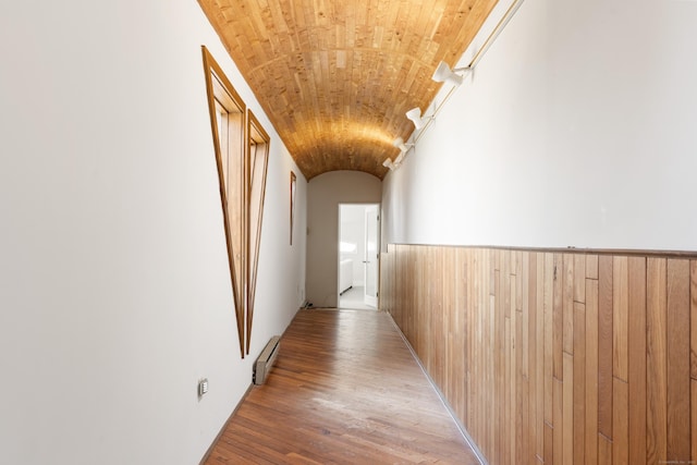 46 Wallace Rd, Branford, CT 06405 - hallway featuring a baseboard radiator, wood walls, light wood-type flooring, and lofted ceiling