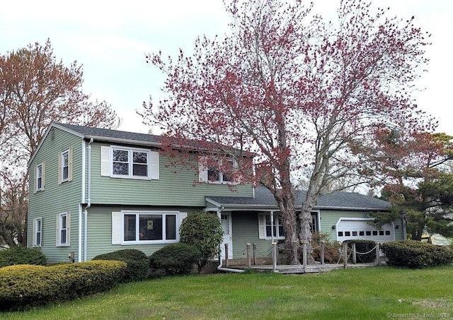 view of front of home featuring an attached garage and a front yard