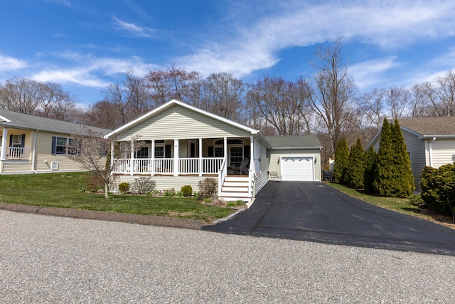 ranch-style home with a porch, driveway, and a front yard