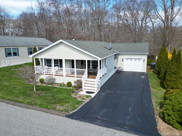 view of front of house with a shingled roof, a front lawn, a garage, a porch, and driveway