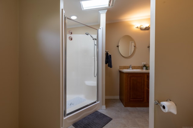 bathroom featuring crown molding, vanity, tile patterned floors, baseboards, and a stall shower