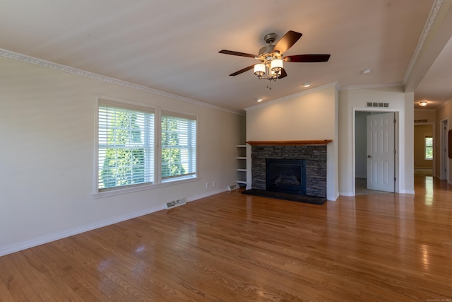 20 Cliff Rd, Ledyard, CT 06339 - unfurnished living room with wood finished floors, ceiling fan, crown molding, baseboards, and a stone fireplace