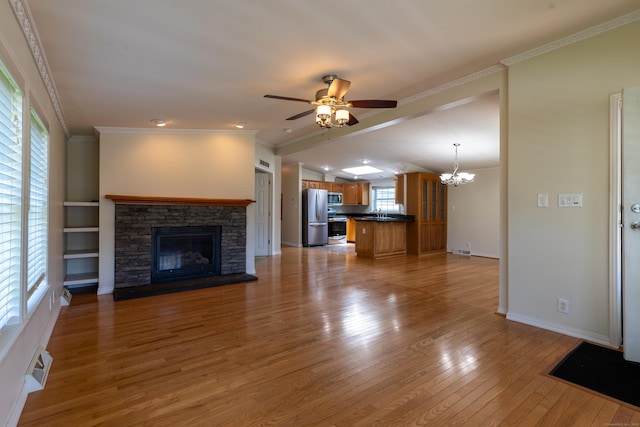 20 Cliff Rd, Ledyard, CT 06339 - unfurnished living room with ceiling fan, a chandelier, a fireplace, light wood-style floors, and crown molding