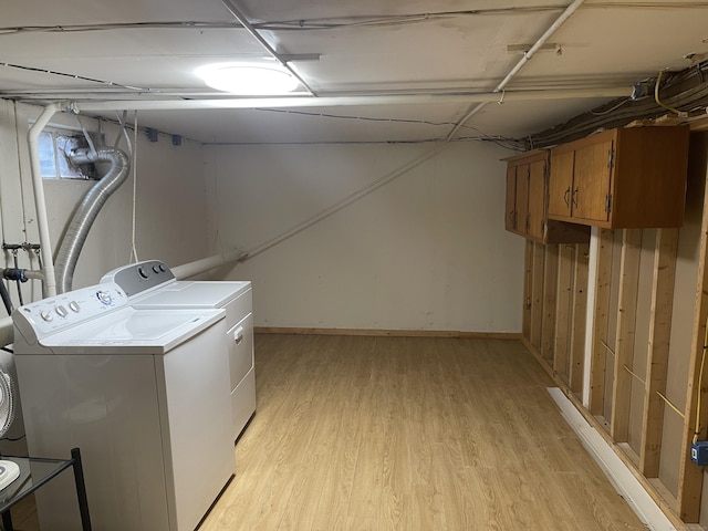 273 Queen St Apt 15E, Southington, CT 06489 - washroom featuring light wood finished floors, baseboards, independent washer and dryer, and cabinet space
