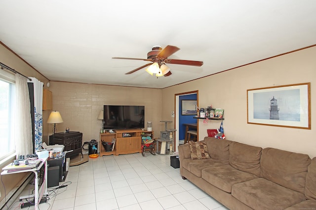 living room with crown molding, a ceiling fan, light tile patterned floors, and a baseboard radiator