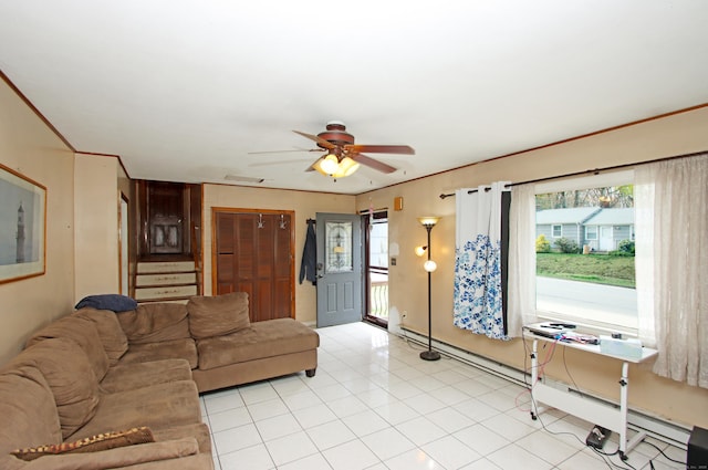 living area featuring stairway, ceiling fan, a baseboard heating unit, and a wealth of natural light