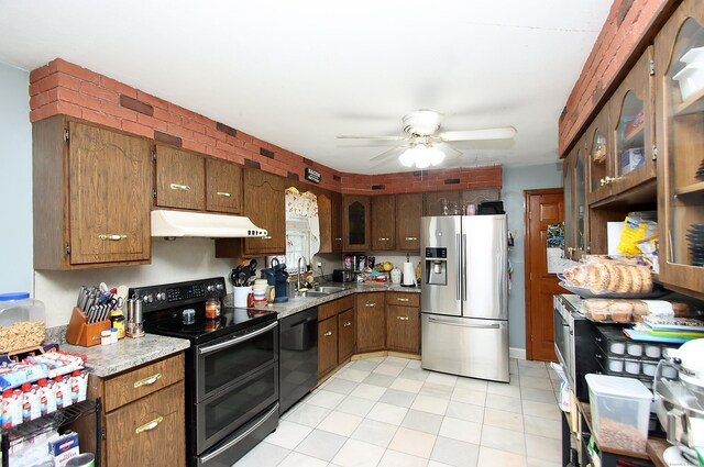 kitchen with black dishwasher, stainless steel refrigerator with ice dispenser, under cabinet range hood, a sink, and double oven range