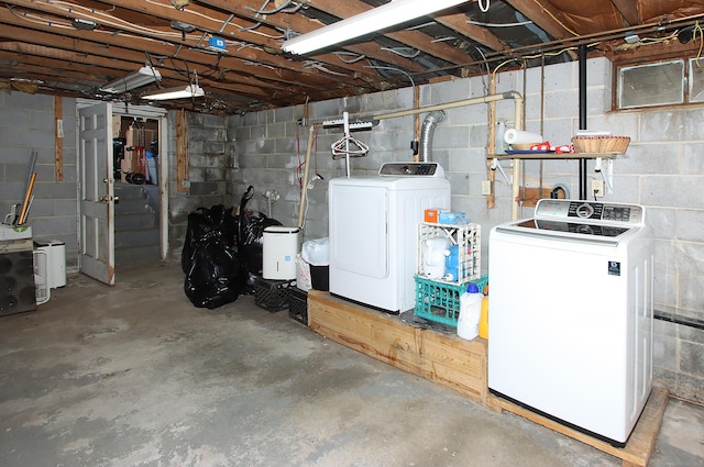 unfinished below grade area with washing machine and clothes dryer