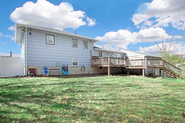 back of house with a lawn, a deck, stairway, and fence