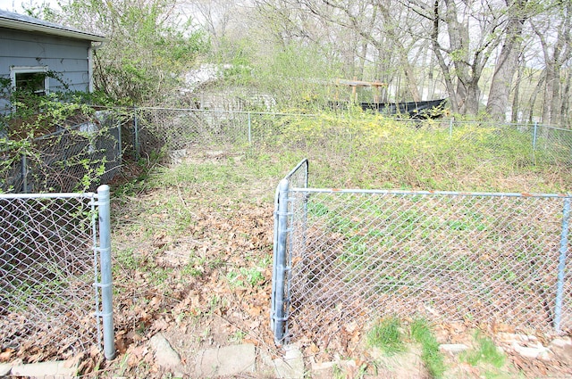 view of yard featuring fence and a gate