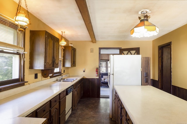 56 Laurel Hill Dr, Woodstock, CT 06282 - kitchen with plenty of natural light, light countertops, wainscoting, white dishwasher, and hanging light fixtures