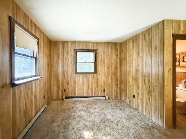 56 Laurel Hill Dr, Woodstock, CT 06282 - empty room featuring a baseboard heating unit, wood walls, carpet flooring, and a baseboard radiator