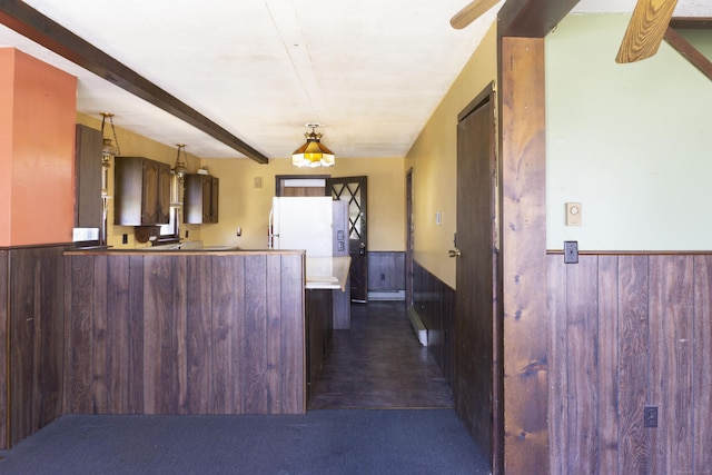 56 Laurel Hill Dr, Woodstock, CT 06282 - kitchen with wainscoting, freestanding refrigerator, a peninsula, wooden walls, and beamed ceiling