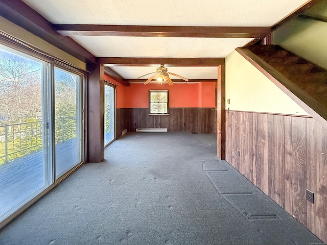 56 Laurel Hill Dr, Woodstock, CT 06282 - carpeted spare room with a baseboard heating unit, beamed ceiling, wooden walls, a wainscoted wall, and ceiling fan