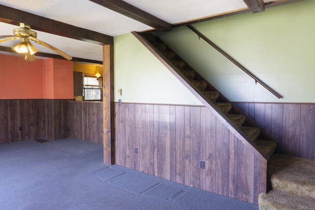 56 Laurel Hill Dr, Woodstock, CT 06282 - stairs with a wainscoted wall, wooden walls, carpet, beamed ceiling, and ceiling fan