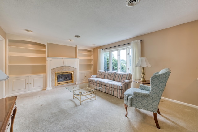 18 Black Birch Rd, Plainville, CT 06062 - living area featuring carpet, built in features, a premium fireplace, and a textured ceiling