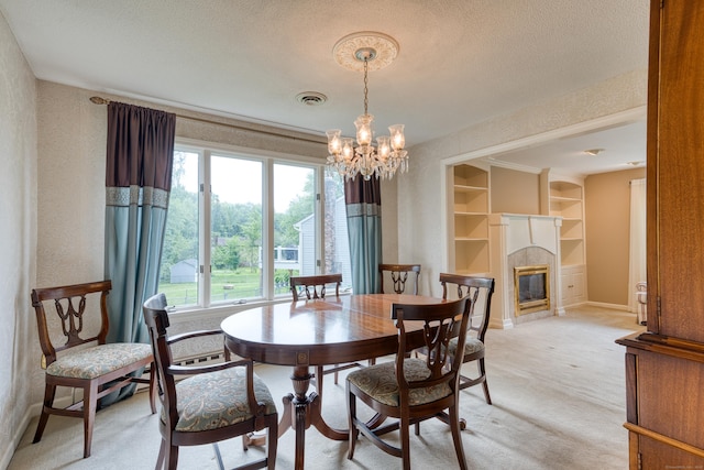 18 Black Birch Rd, Plainville, CT 06062 - dining area featuring healthy amount of natural light, a chandelier, a tile fireplace, light colored carpet, and a textured ceiling