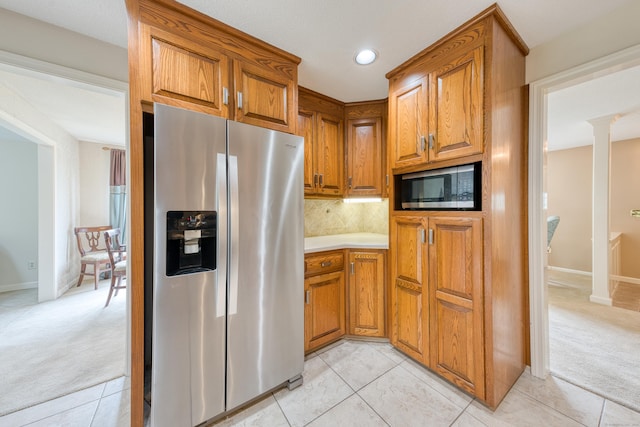 18 Black Birch Rd, Plainville, CT 06062 - kitchen featuring appliances with stainless steel finishes, light colored carpet, brown cabinets, decorative backsplash, and light countertops
