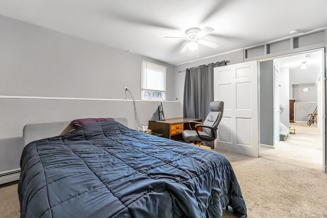 carpeted bedroom with ceiling fan and a baseboard radiator